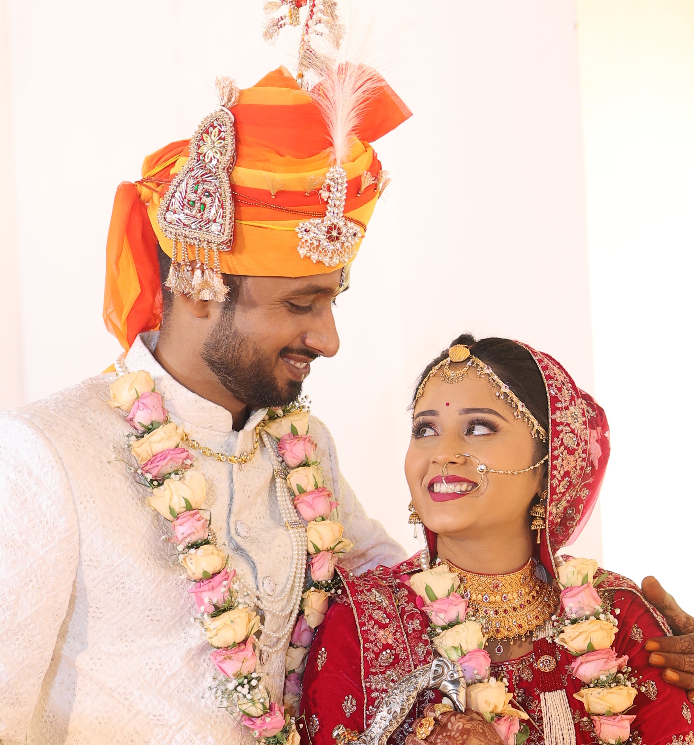 Bride and groom holding hands in sunset